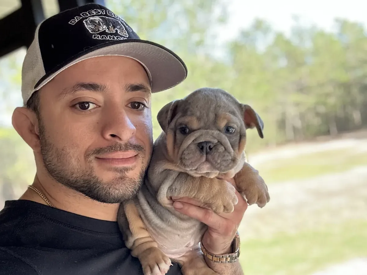 Jason soares holding mini bulldog puppy