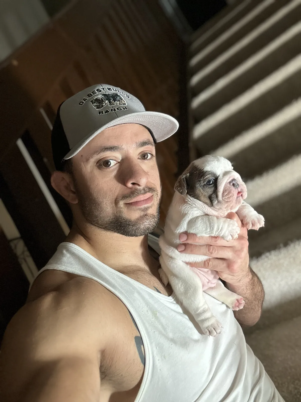 Jason Soares holding a young English bulldog puppy
